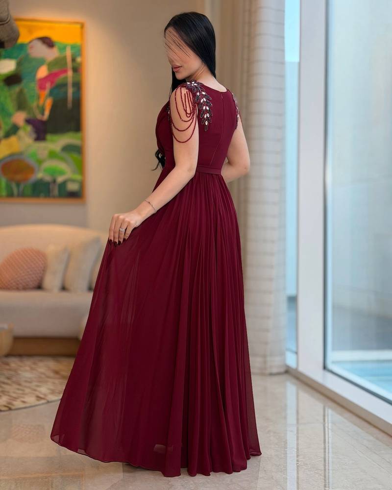 Long burgundy pleated dress with a draped collar