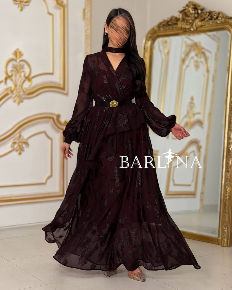 A burgundy floral dress with a gold belt