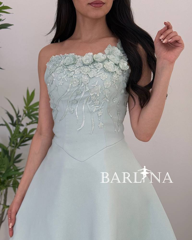 A soft Tiffany dress adorned with delicate rose embroidery