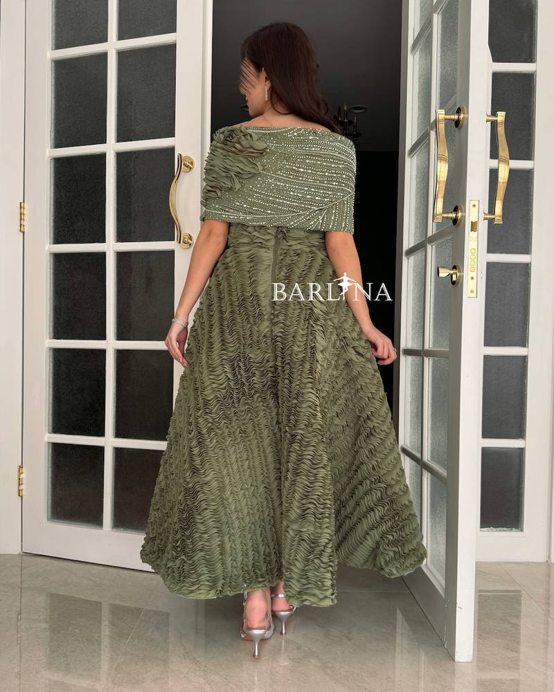 Olive green dress with a soft cut and ruffled details