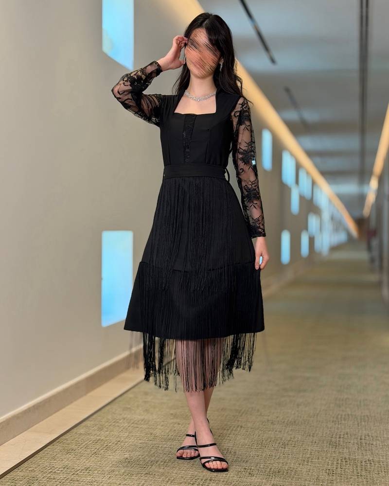 Black dress with lace sleeves and long fringe