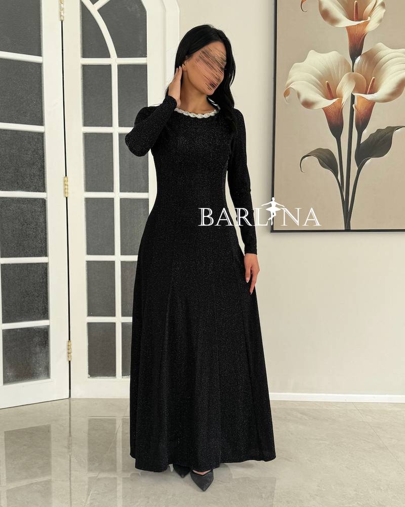 A shiny black dress with a wide cut and a studded collar