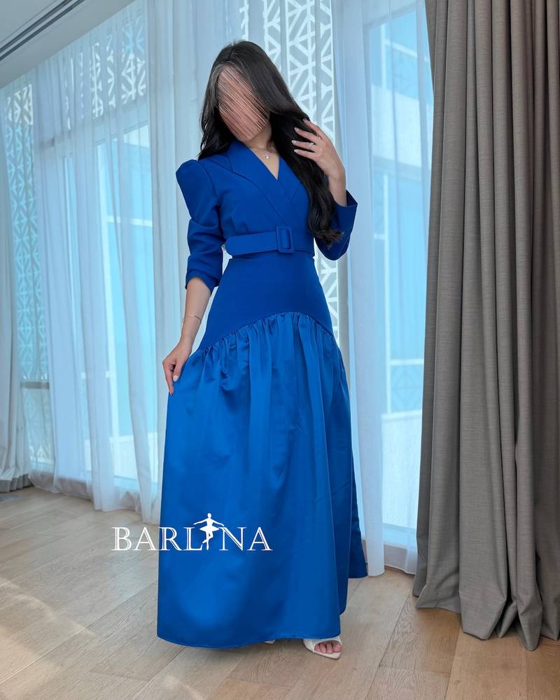 Indigo blue dress with structured shoulders and a belt