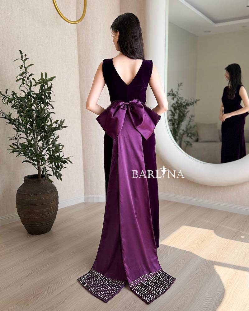 Dark purple velvet dress with a bow train