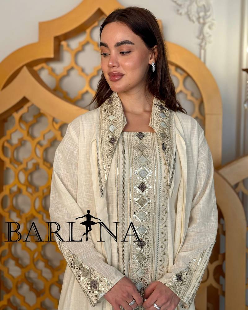 A cream-colored jalabiya with embroidery details and an oriental touch.