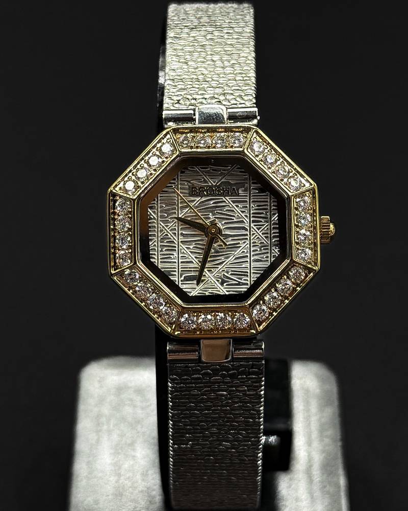 An octagonal bezel wristwatch studded with gemstones