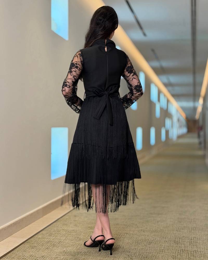 Black dress with lace sleeves and long fringe