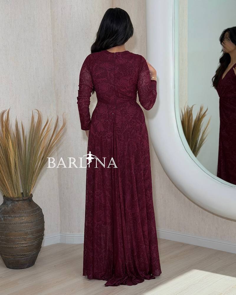 A soft burgundy dress with a cut that accentuates the waist.