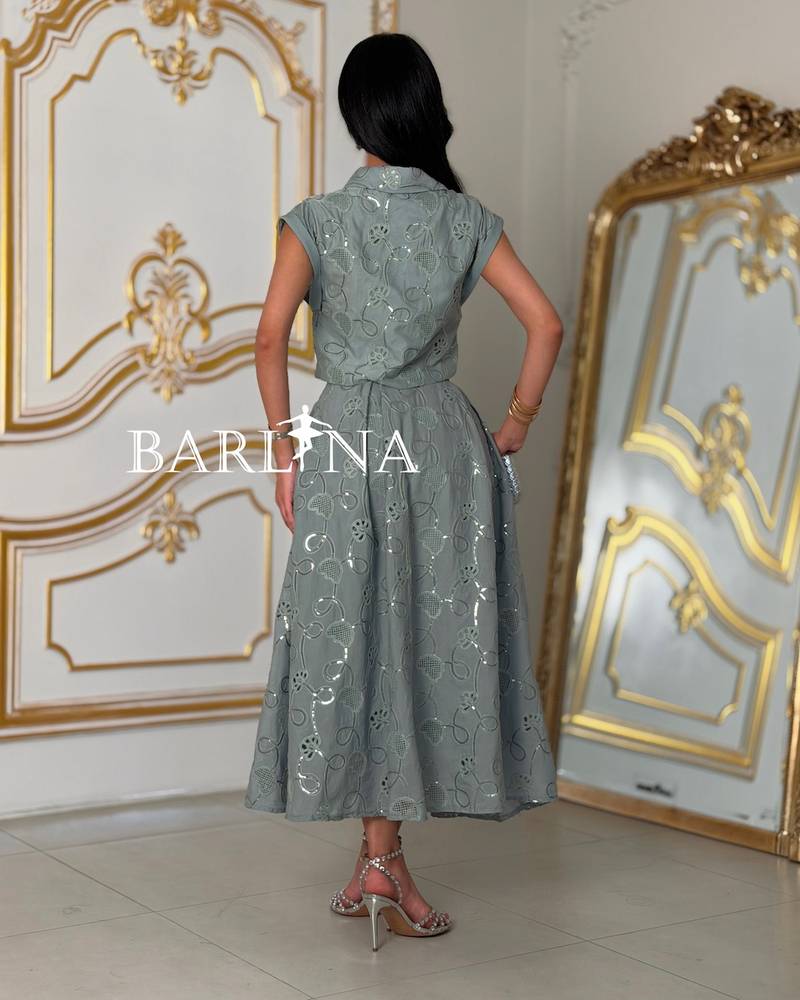A soft set with a short blouse and crystal buttons