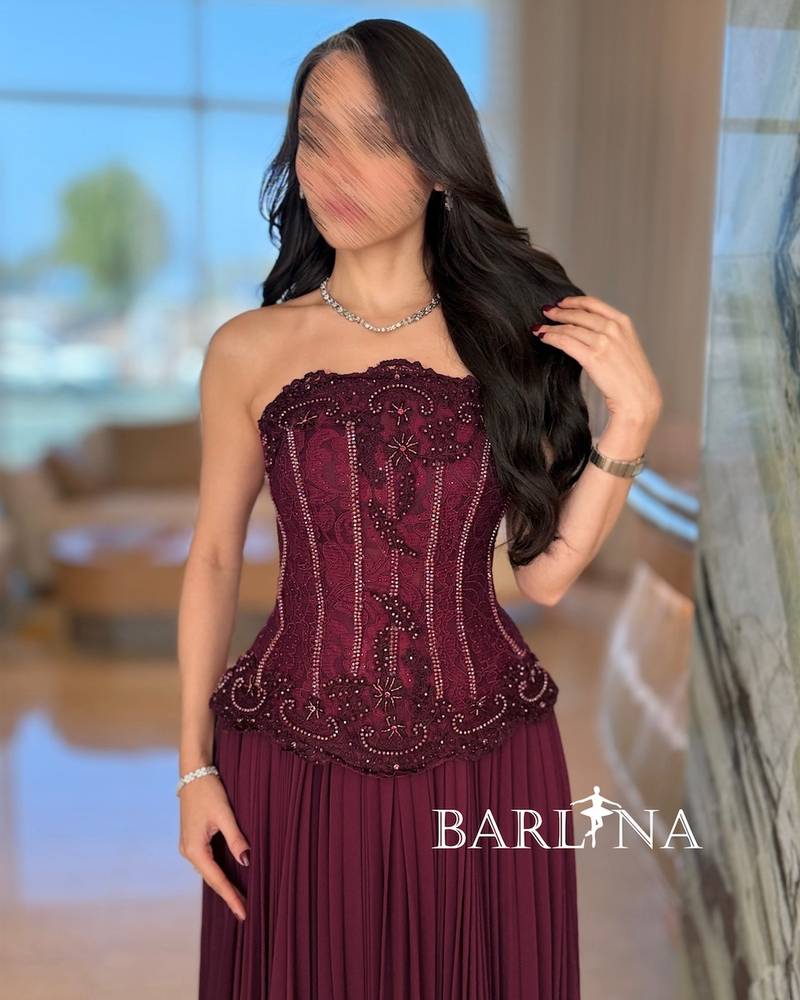 Burgundy dress with multiple pleats and a corset cut
