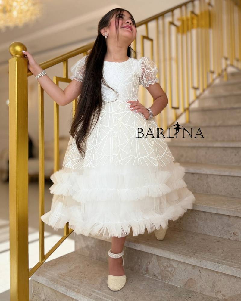 White patterned girl's dress with ruffled edges