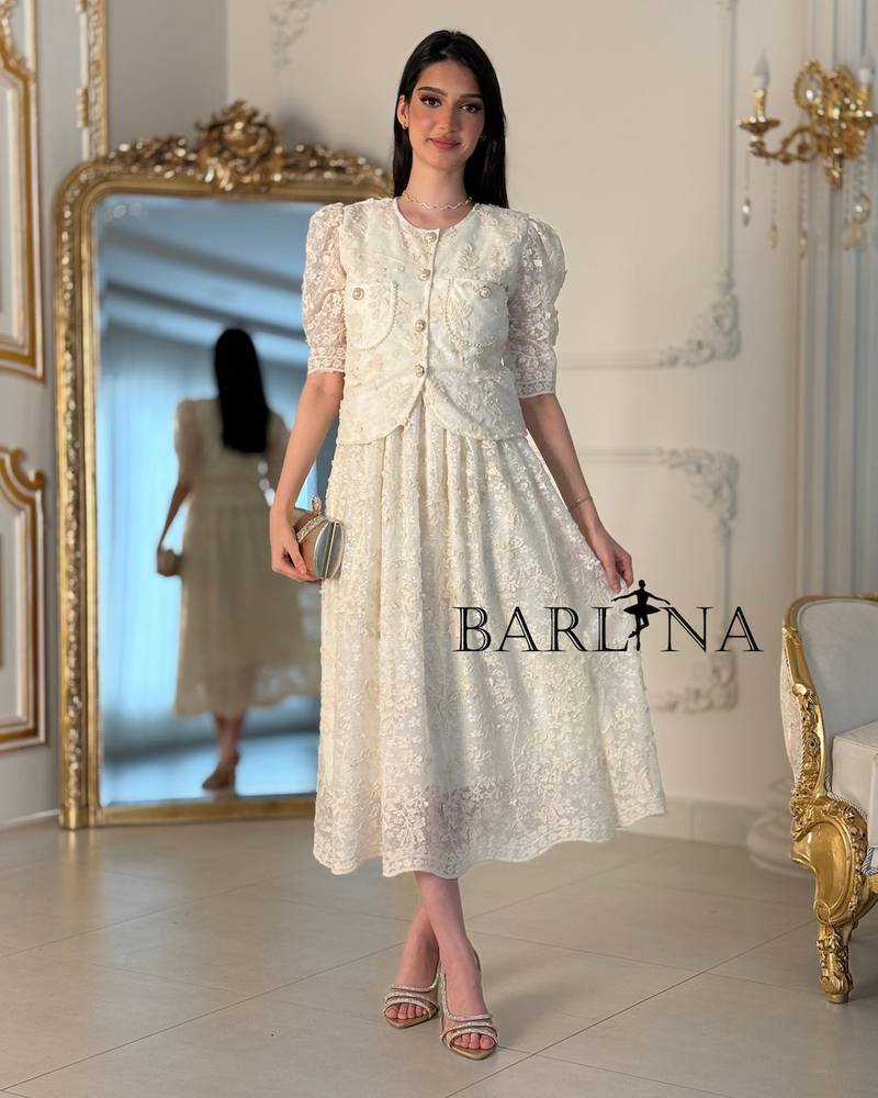 A two-piece off-white dress with an elegant lace design