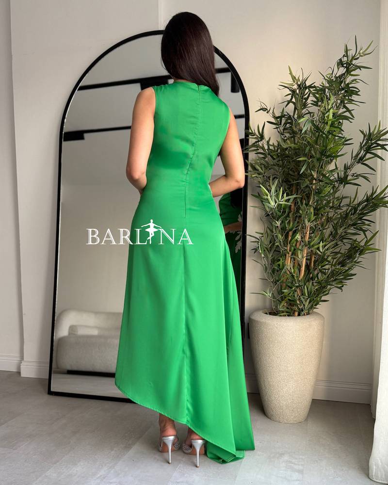 Green dress with pleated details at the waist