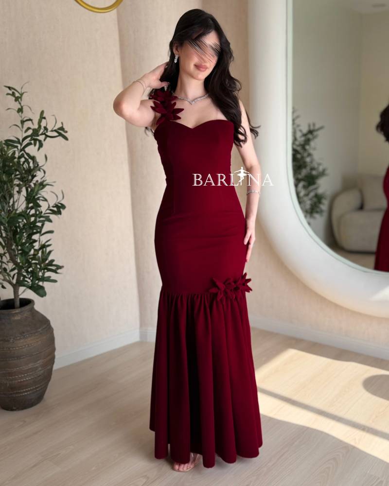 Elegant burgundy dress adorned with roses on the shoulder