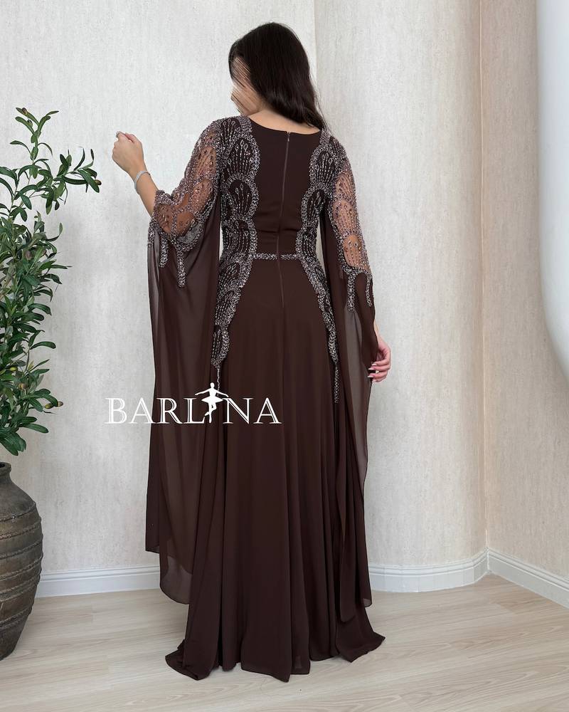 Long brown dress with a sheer cape