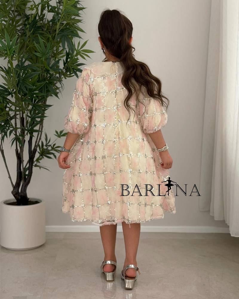 Beige girl's dress decorated with delicate flowers