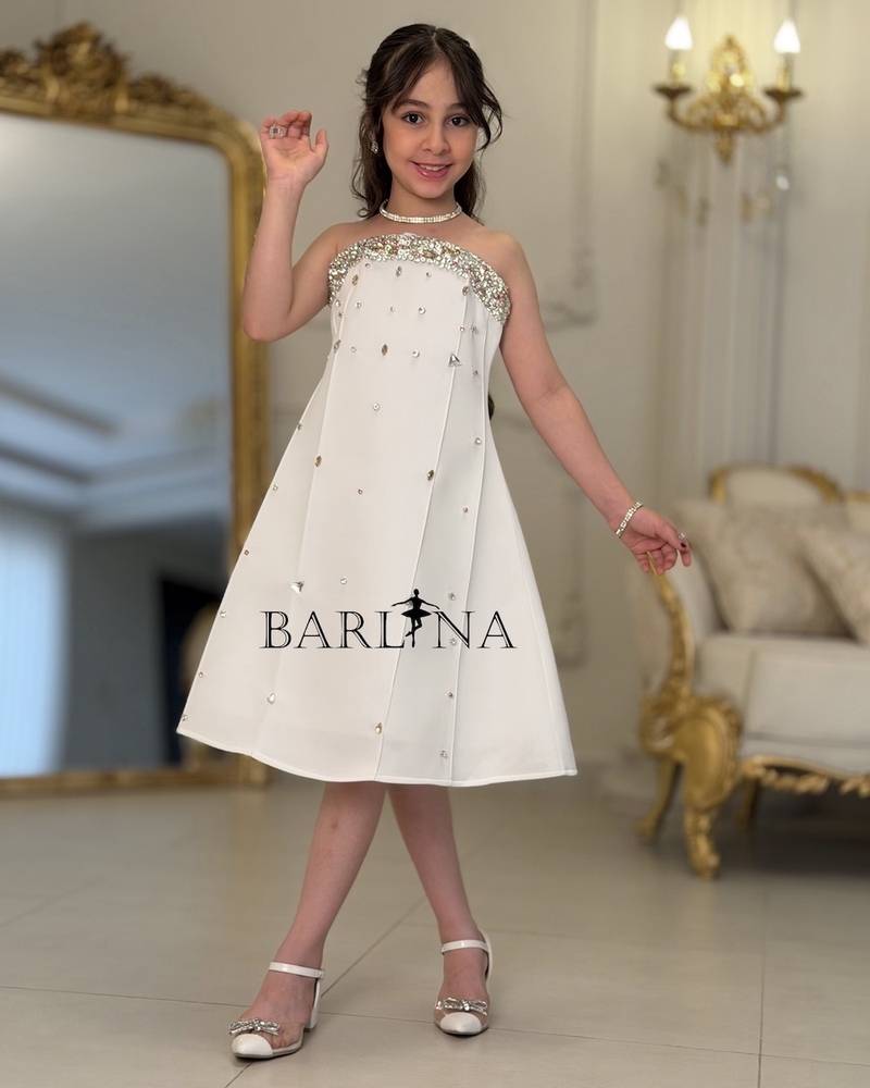 White girl's dress decorated with crystal details