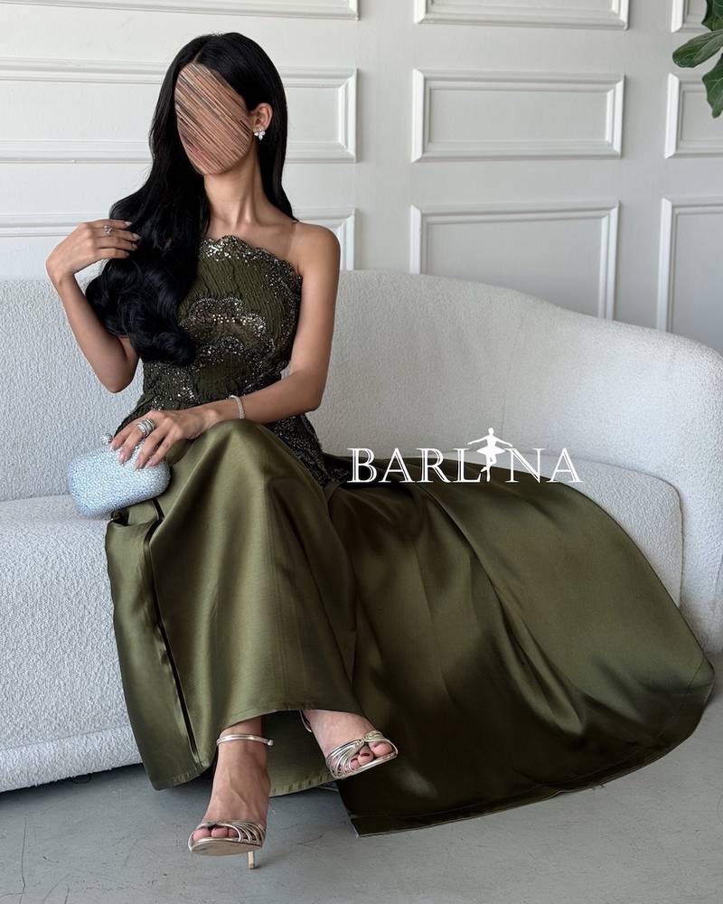 Olive green dress with layered embroidery and a prominent design