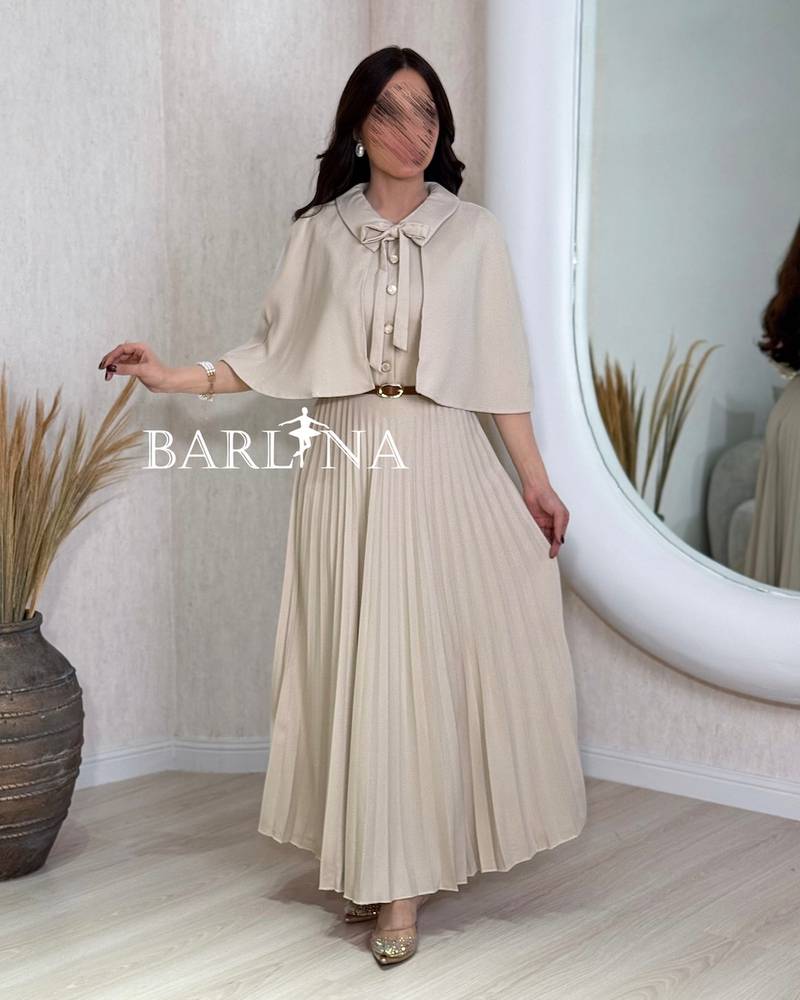 Beige pleated dress with a short flowing cape