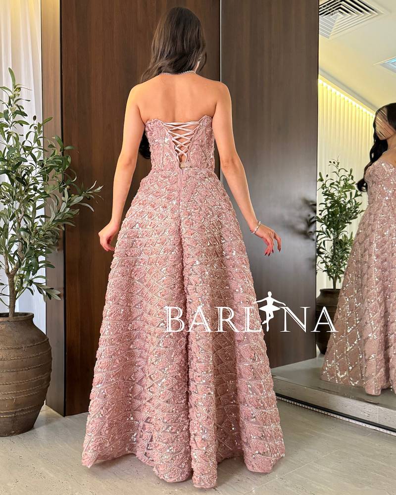 Pink evening dress with shiny embroidery and a geometric pattern