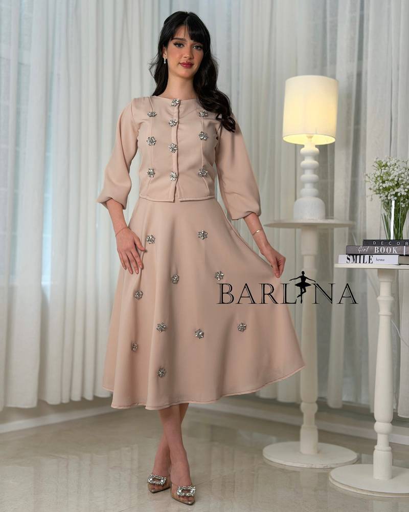 A beige set adorned with scattered shimmering embroidery