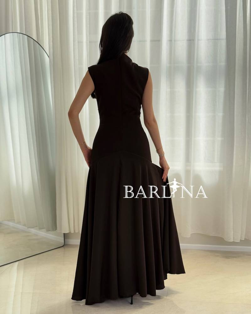 Black dress with crystal embellishments and a draped collar