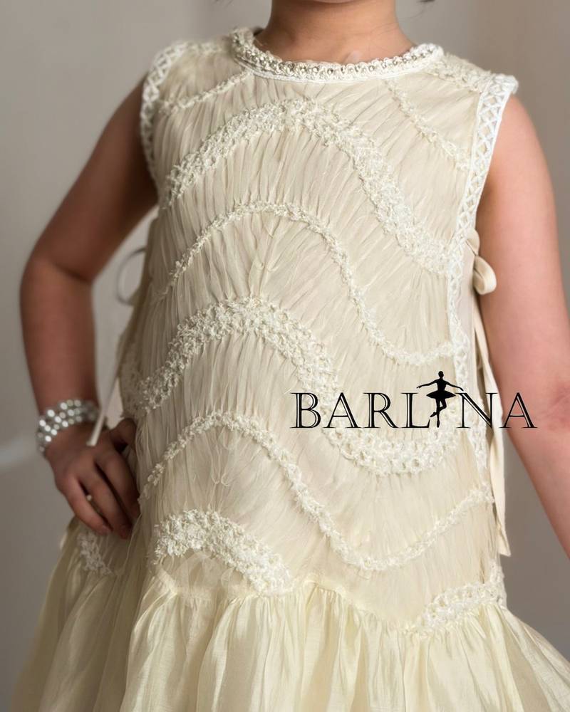 Girls dress in a soft cream color