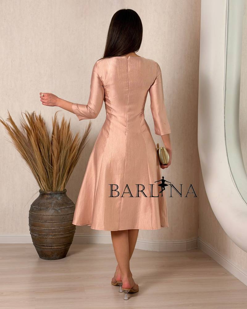 A soft midi dress adorned with a delicate rose