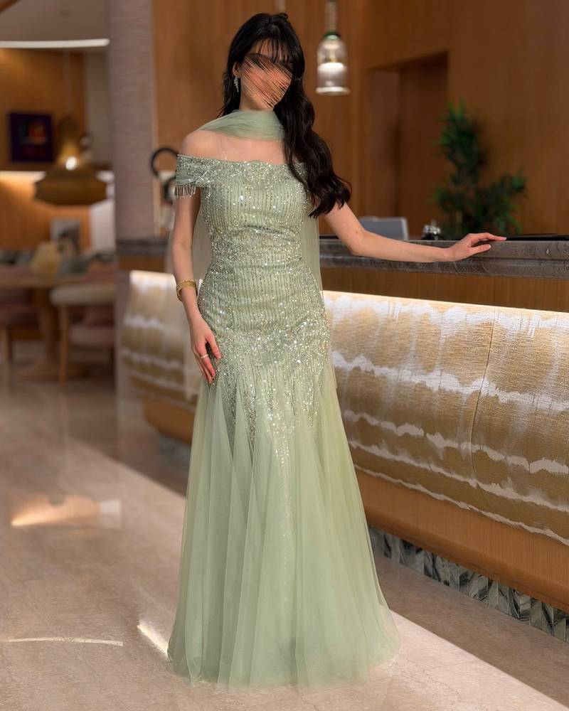 Light green evening dress with a tulle shawl