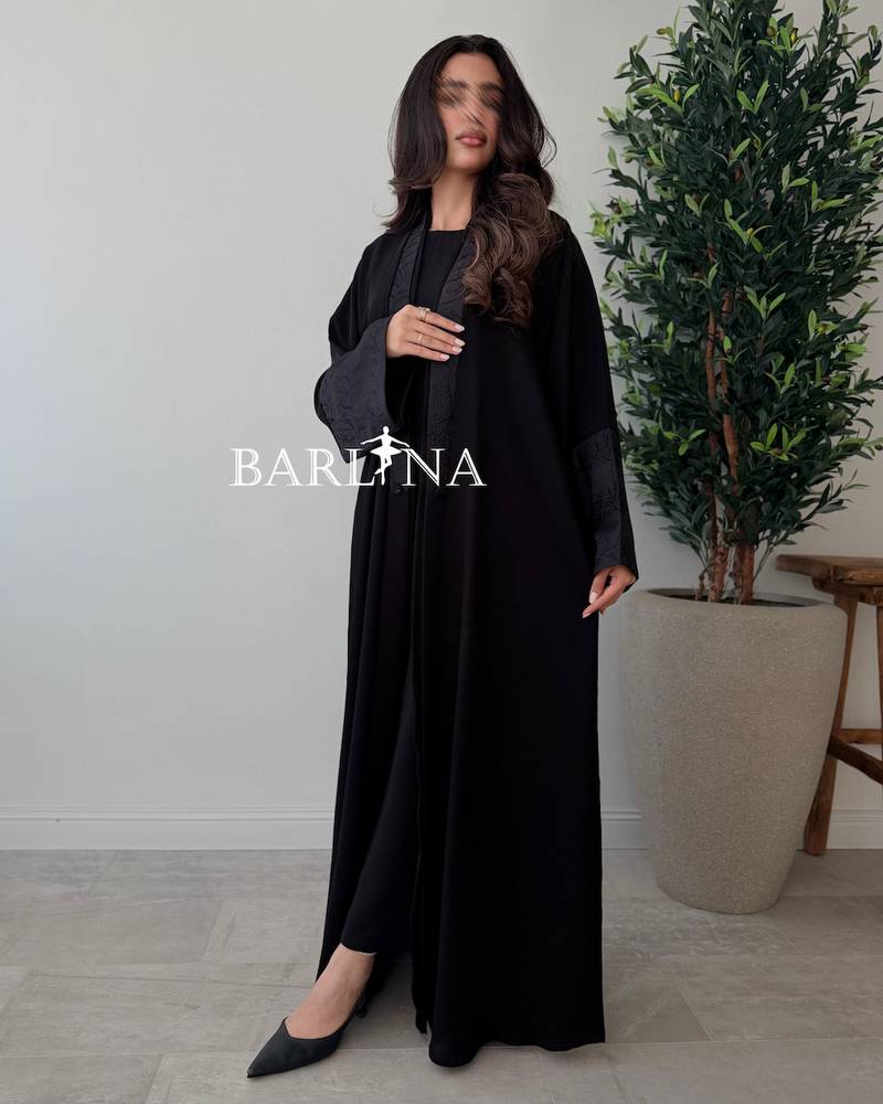 Black abaya with a flowing design and light embroidery