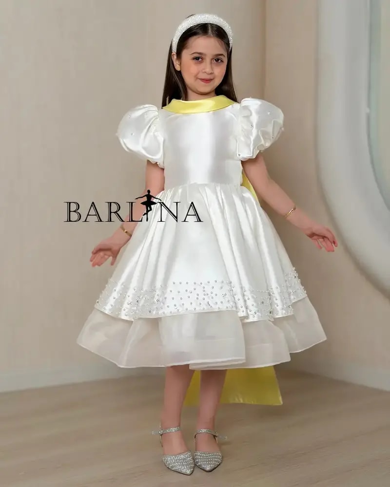 Girls' white evening dress with a yellow touch