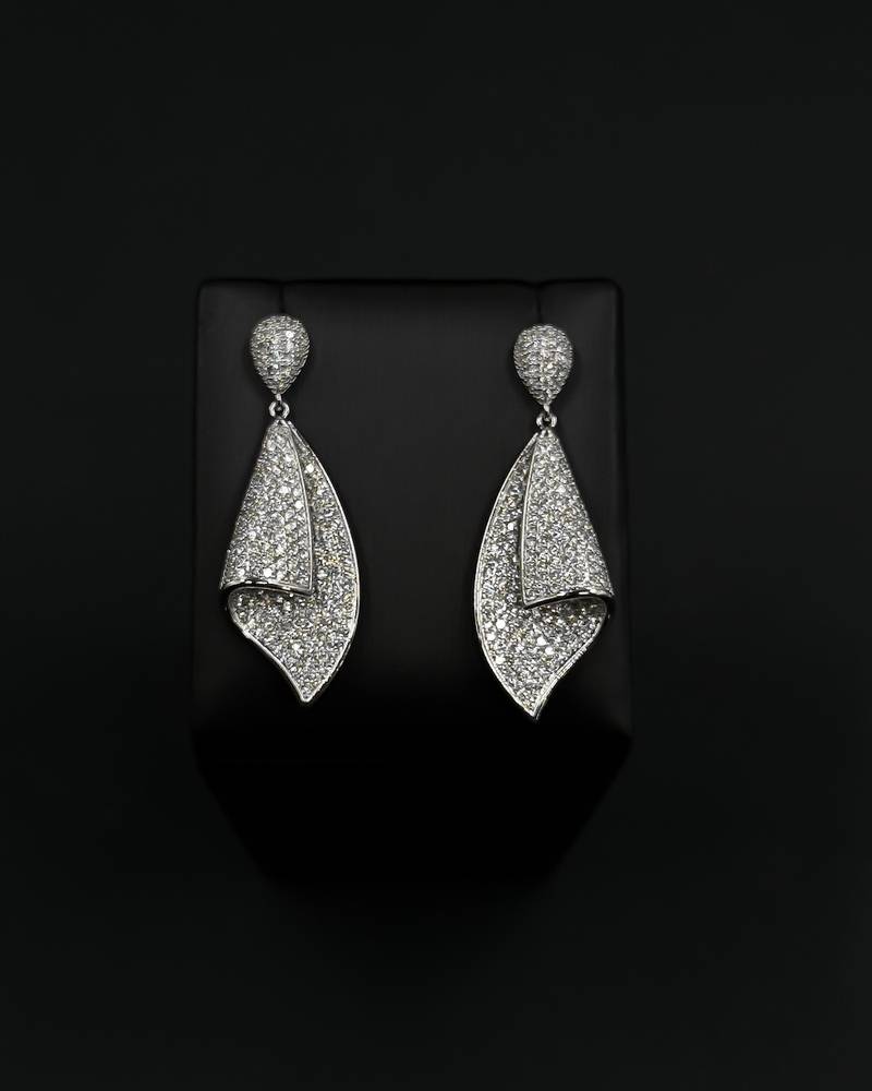 Diamond-studded silver earrings with a twist design