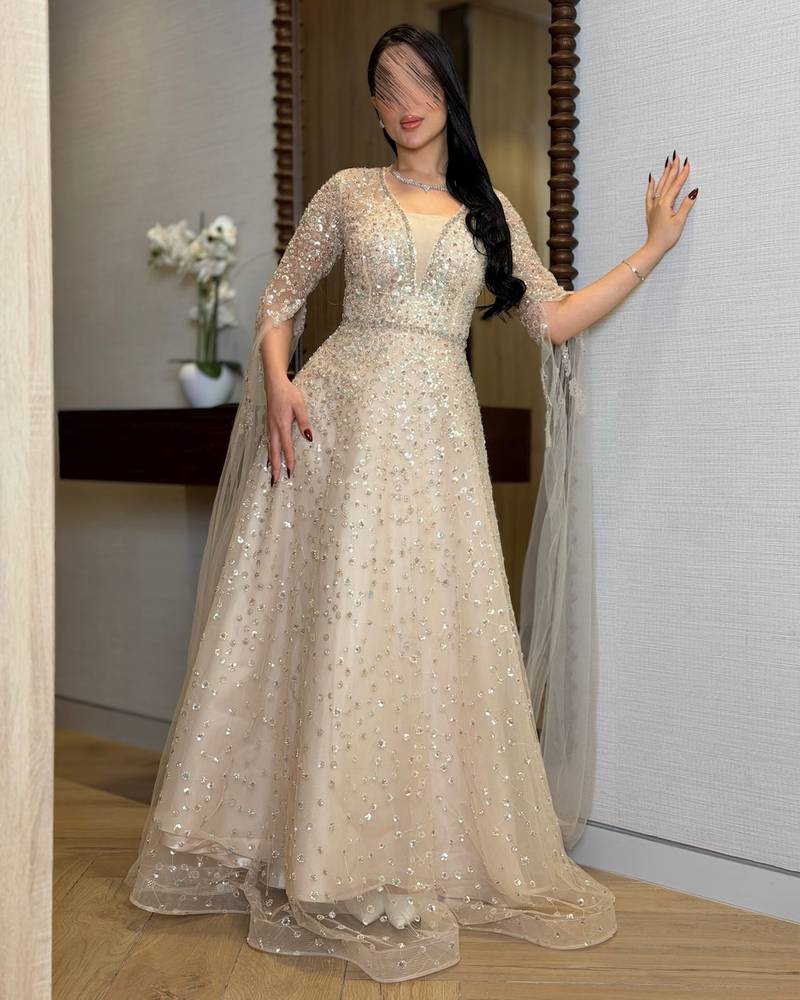 Beige evening dress with sheer draped sleeves