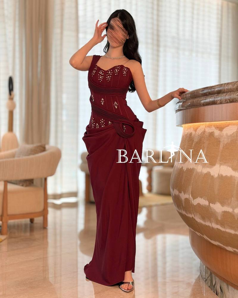 Burgundy dress with shimmering embroidery and draped design
