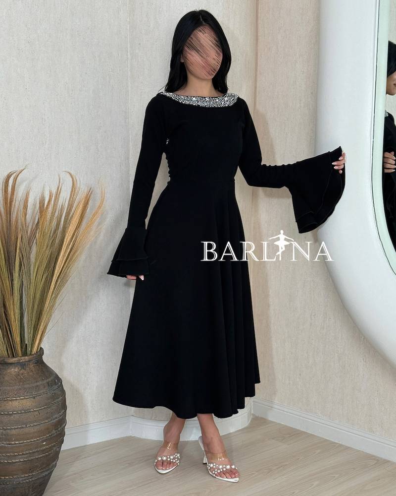 A soft black dress with a crystal-embellished collar.