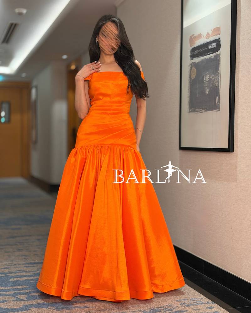 A shimmering off-the-shoulder evening dress