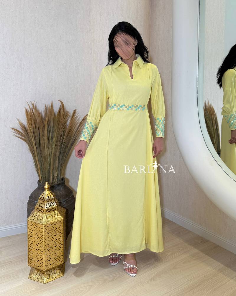 Yellow jalabiya with turquoise embroidery at the waist