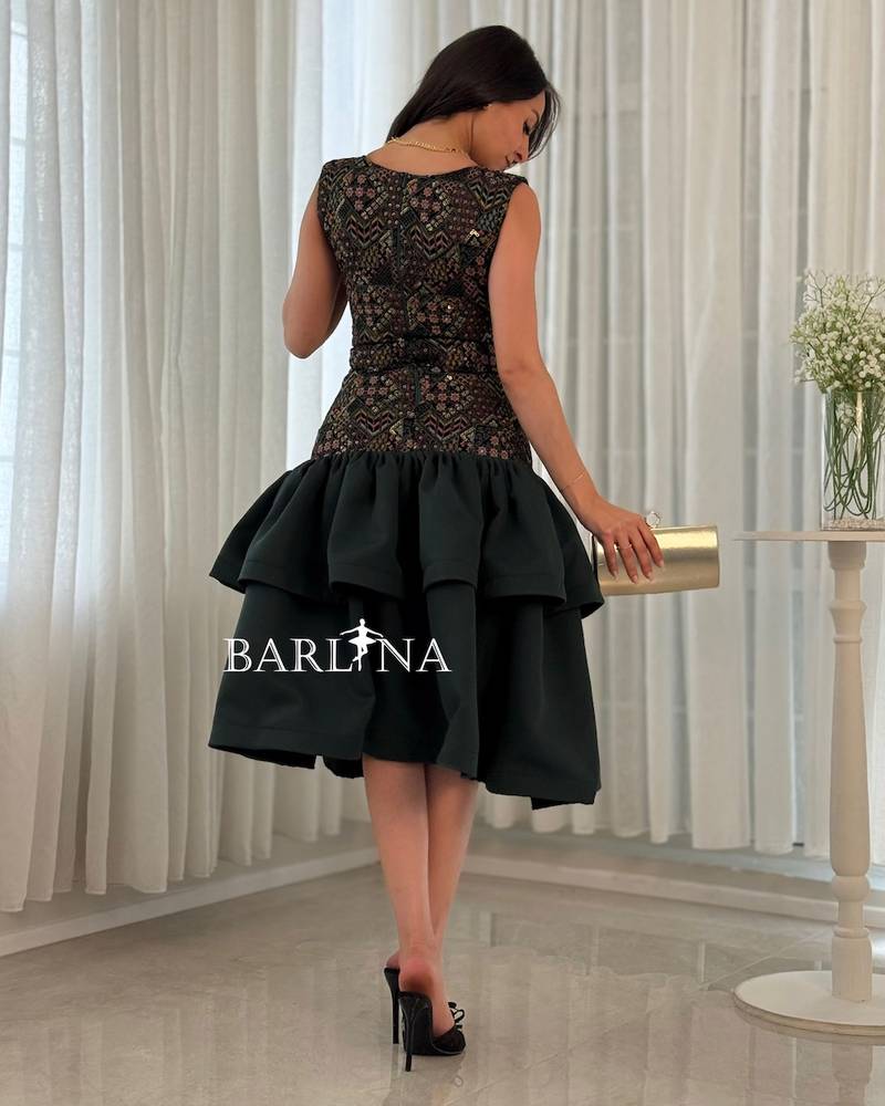 Green dress with layers and embroidery on top