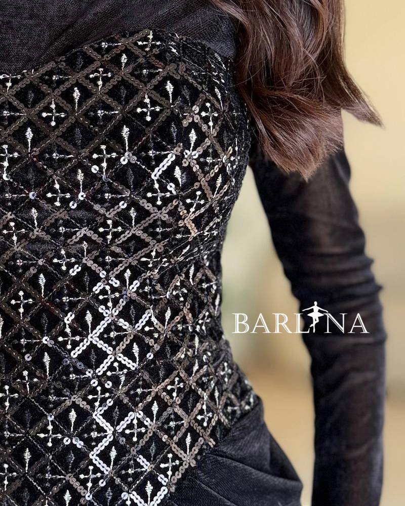 A black velvet dress with a sophisticated sheen and draping.