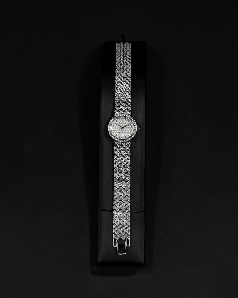 Silver wristwatch with a round dial and a wide strap