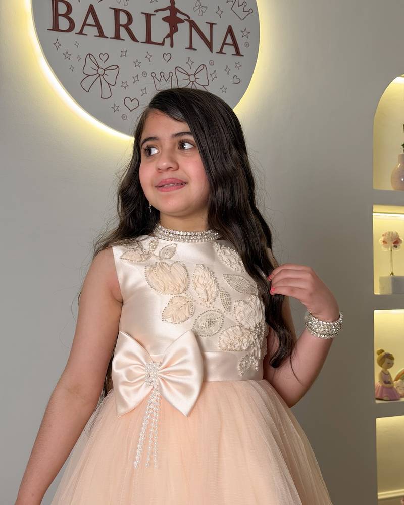 Girls' peach tulle dress with a large bow