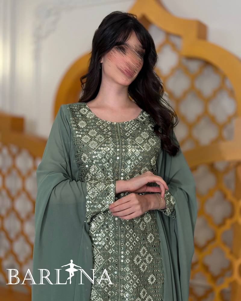 Green jalabiya embroidered with a traditional design