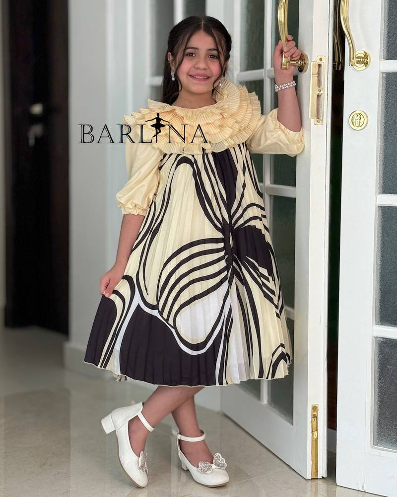 Girls' dress with a ruffled top and a modern pattern