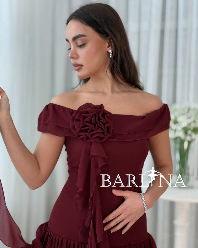 A soft, layered dress with a fabric rose.