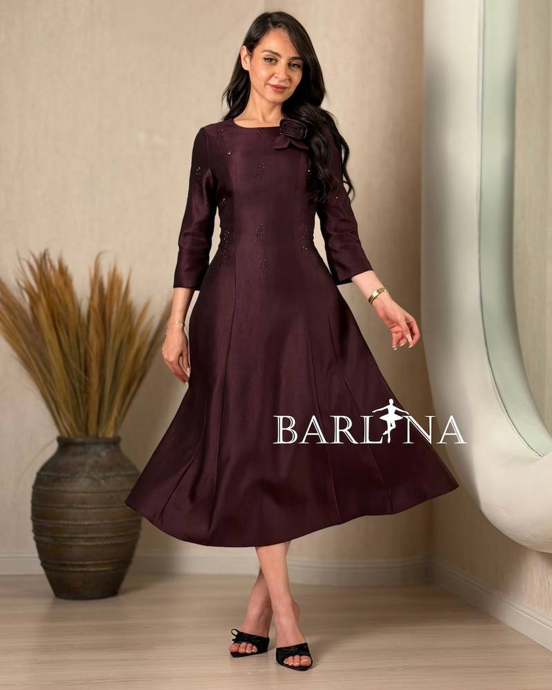 A soft midi dress adorned with a delicate rose