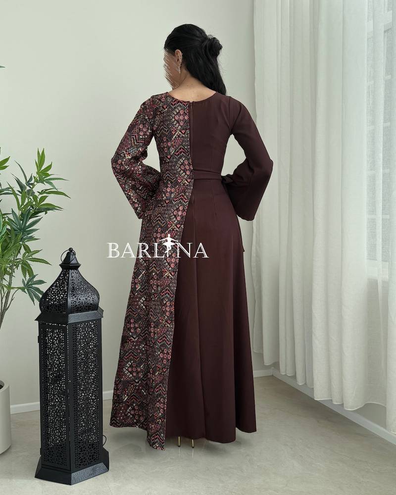 A maroon djellaba with a colorful traditional pattern