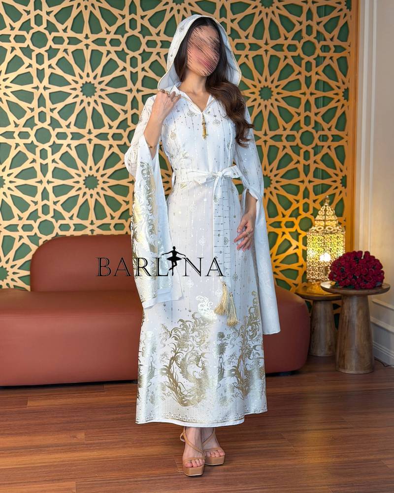 White jalabiya embroidered with gold and with flowing sleeves