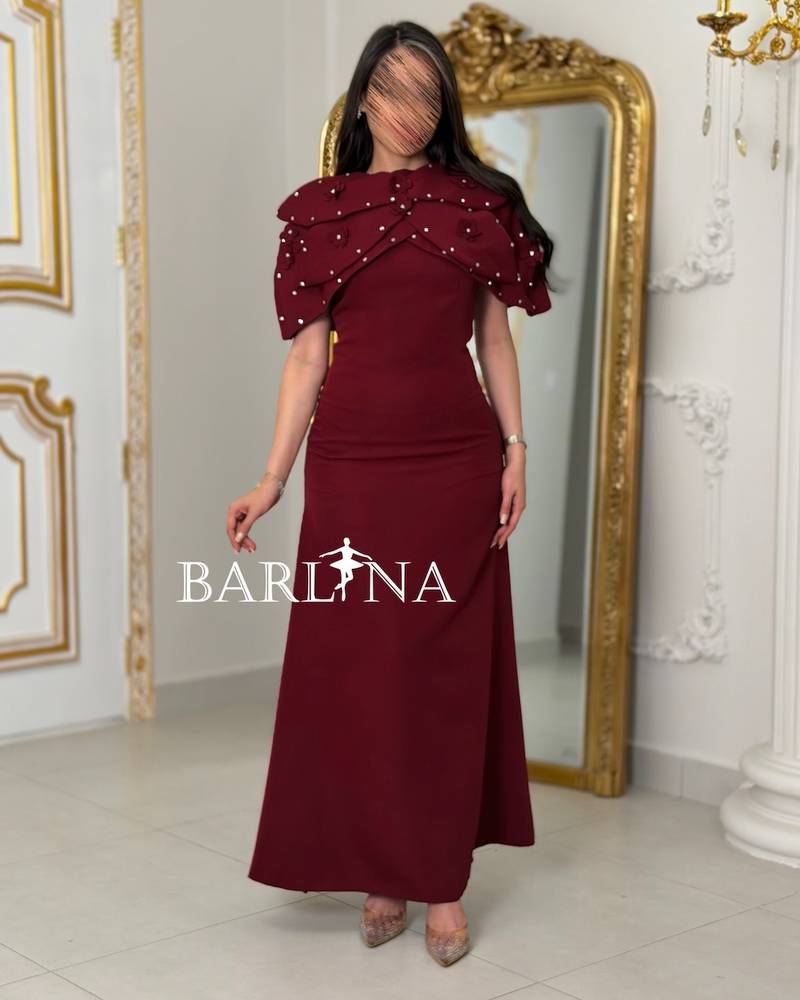 Burgundy dress with a pearl-embellished shoulder piece