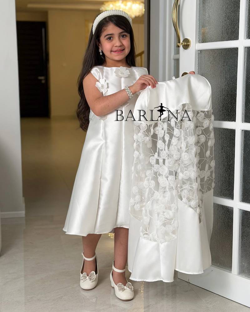 White dress with a lace cape and delicate embroidery