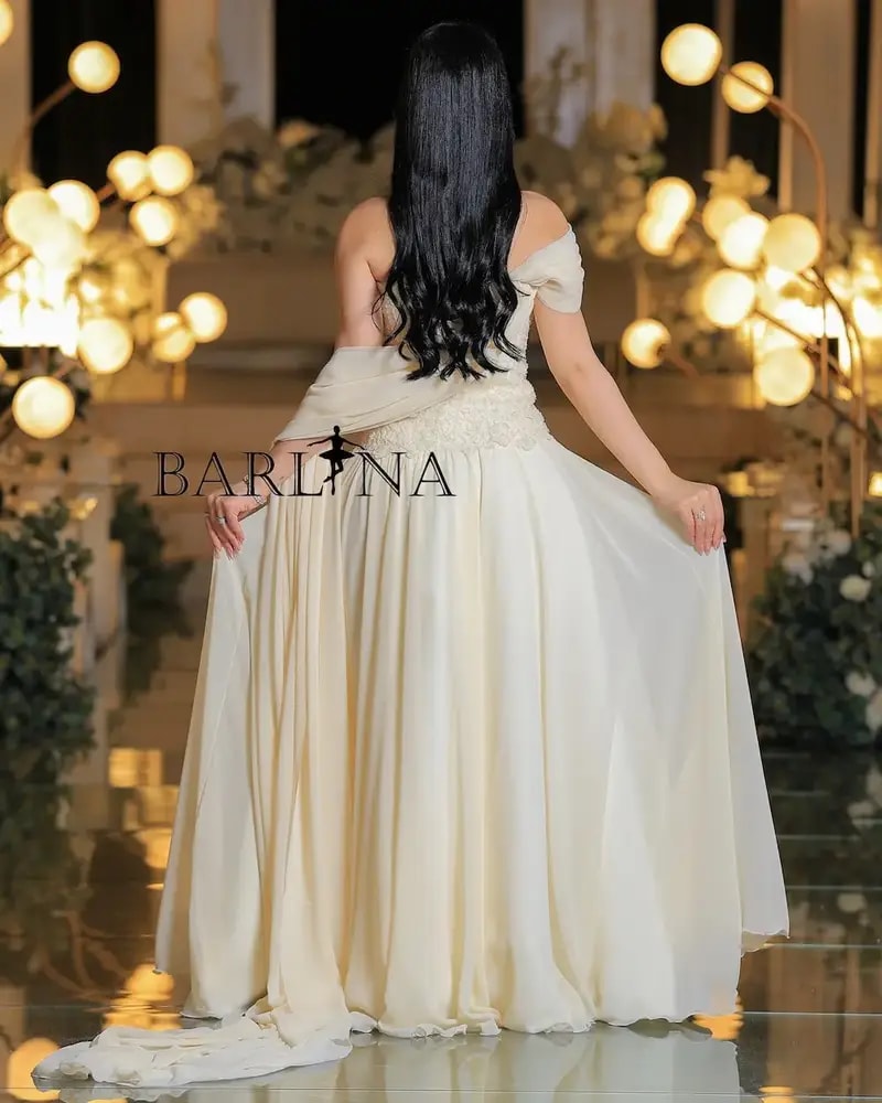Royal ivory evening gown with draped sleeves